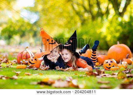 Kids With Pumpkins In Halloween Costumes