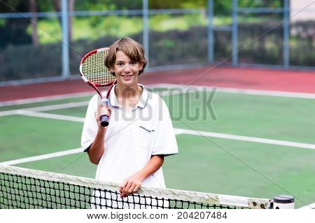 Child Playing Tennis On Outdoor Court