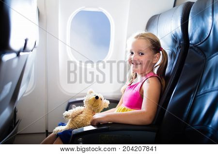 Child In Airplane. Flight With Kids. Family Flying.