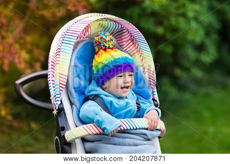 Baby Boy In Stroller In Autumn Park