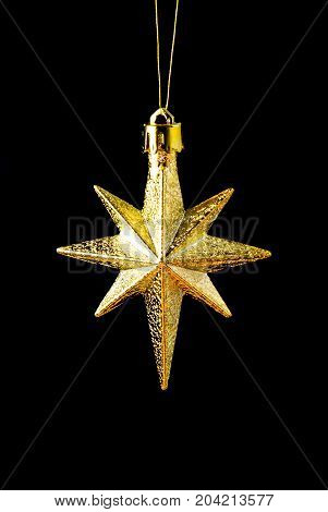 gold(en) star on dark backgroundChristmas bauble close up