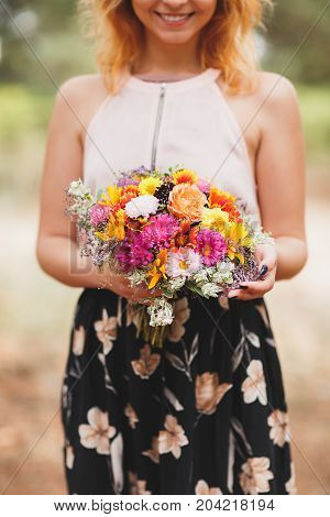 Close-up photo of body parts pretty girl. with bright gift, standing in the forest. Lifestyle concept.