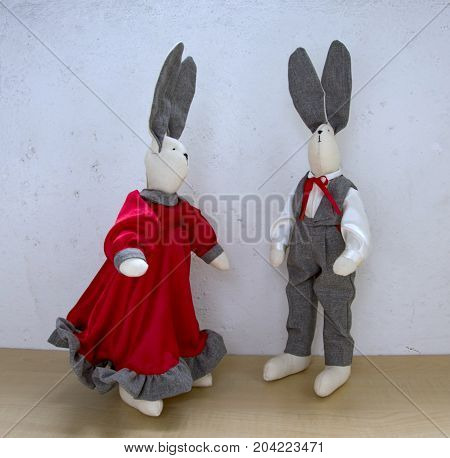 Cute Rabbits, A Couple For A Walk In Front Of A Light Wall, A Girl In A Red Satin Dress And A Cheval