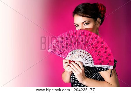 Flamenco Carmen Beautiful Woman In Black Dress With A Red Rose In Her Hair On Dark Background. Argen