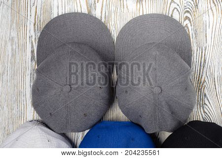 Snapback hats on white wooden background isolation