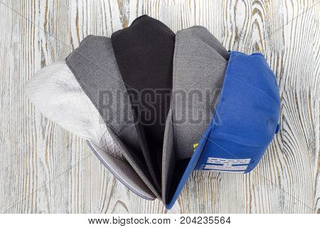 Snapback hats on white wooden background isolation