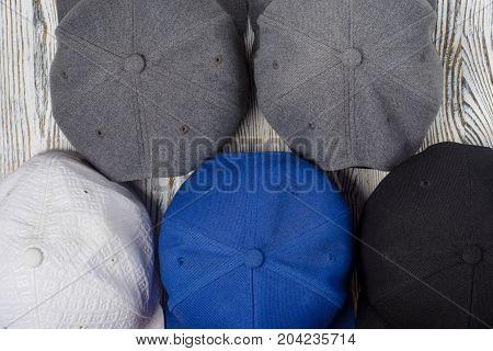 Snapback hats on white wooden background isolation