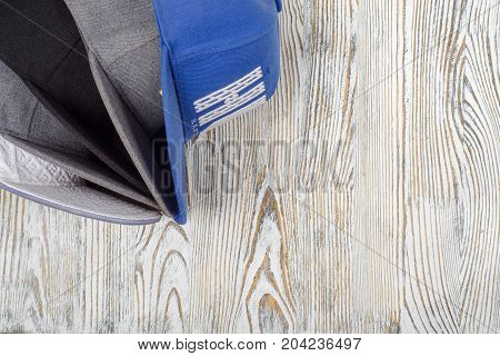 Snapback hats on white wooden background isolation