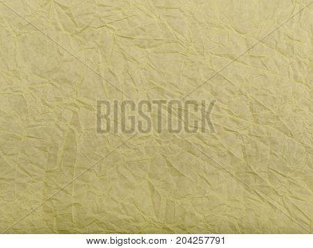 Yellow wrinkled paper as a background. Light yellow wall-peper as a texture.