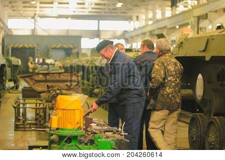 ZHYTOMYR, UKRAINE - Oct 10, 2014: Russian armored personnel carrier with a weapon and tanks in the hangar