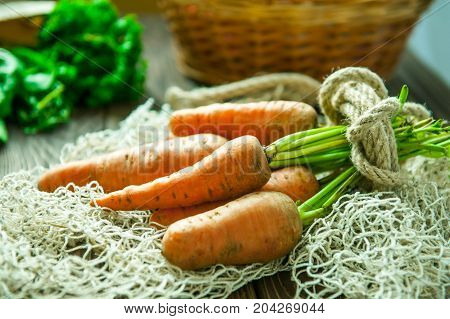Bunch Of Fresh Organic Dirty Carrots And Oher Purchased Products From Farm Market On The Wooden Back