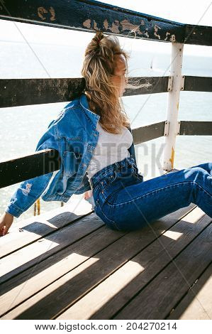 Young Beautiful Woman In Jeans Clothes Outdoors. Portrait Of A Girl With Freckles On Her Face, Styli