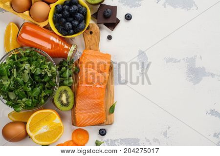 Healthy food good for eyes over white table. Productis fos excellent vision. Space for text