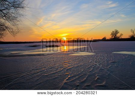 Sunset Over A Frozen River Dnieper On Winter