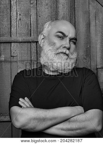 Senior man. Portrait of senior man with white beard over a wooden background