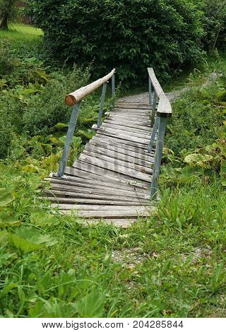 Wooden bridge crooked and broken in the Tyrolean Alps