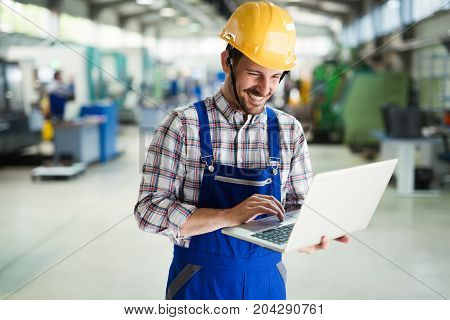 Supervisor doing quality control and pruduction check in metal factory