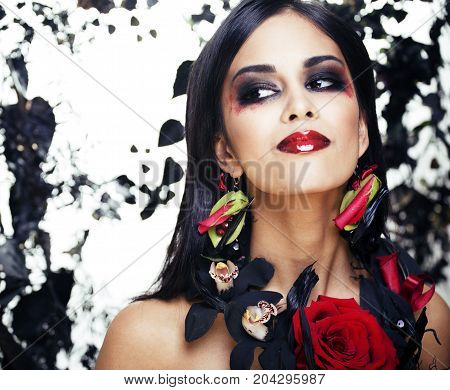 pretty brunette woman with rose jewelry, black and red, bright make up kike a vampire closeup red lips, halloween concept