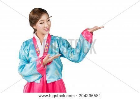 Korean Woman with Hanbok the traditional Korean dress gesturing open hand with copy space for product or text in white background with clipping path.