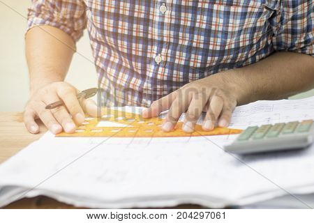 Engineer drawing sketch and working project in work palce
