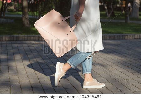Woman walking with pink bag in the morning. Lifestyle morning modd concept.
