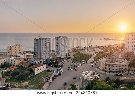 ALBANIA DURRES - September 22 2015: View from above on the embankment of the seaside town of Durres located on the Adriatic coast. Sunset sunset overlooking the Venetian Tower with a cafe on the roof.