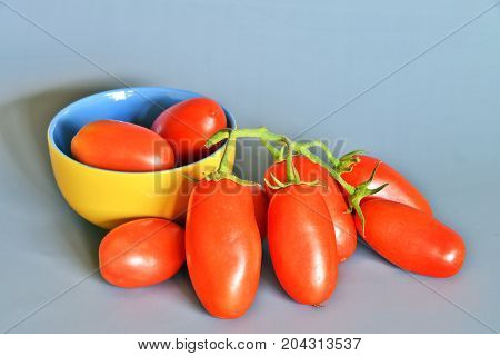 Tomatoes San Marzano, Campania, italy

Group of tomatoes San Marzano, bunch cluster, still life on gray-blue background