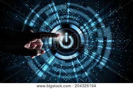Hand pressing power button on blue digital background