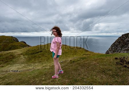 View of Girl looking out over Slieve League Cliffs, County Donegal, Ireland