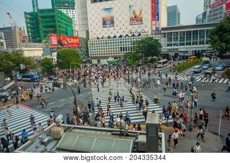 TOKYO, JAPAN JUNE 28 - 2017: Top view of crowd of people crossing in Shibuya street, one of the busiest crosswalks in the world, in the Ginza District in Tokyo, Japan.