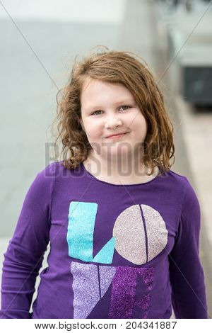 View of Young little girl portrait looking and smiling at the camera.