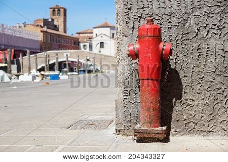 Old red fire hydrant in the street. Fire hidrant for emergency fire access .