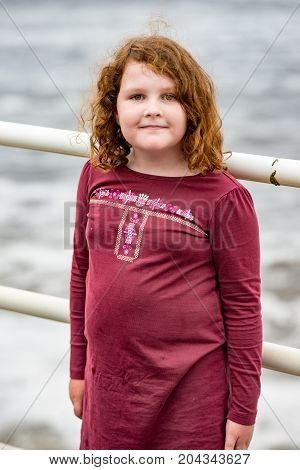 View of Young little girl portrait looking and smiling at the camera.