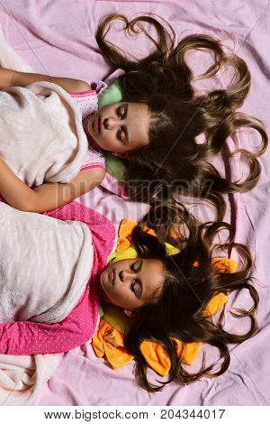 Kids With Motionless Faces And Heart Shaped Hair In Bed