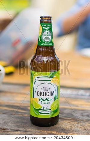 Polish Okocim Radler Beer With Lime And Lemon In A Opened Bottle On A Wooden Table On August 2017 In