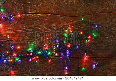 Christmas rustic background - vintage planked wood with lights and free text space.