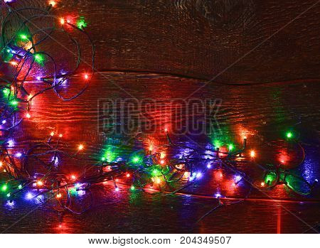 Christmas rustic background - vintage planked wood with lights and free text space.