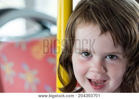 View of Young little girl portrait looking and smiling at the camera.