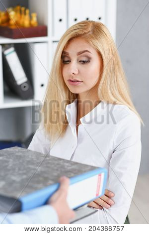 Female Employee Show Pack Of Documents To Manager