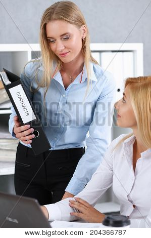 Female Employee Show Pack Of Documents To Manager