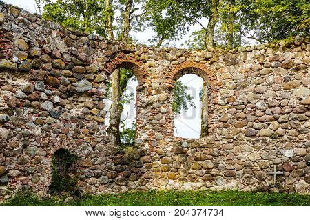very old Kazdangas church wall of stones.