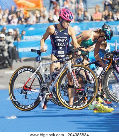 STOCKHOLM - AUG 26 2017: Female triathletes Taylor Spivey (USA) and competitors taking of helmets in the transition zone in the Women's ITU World Triathlon series event August 26 2017 in Stockholm Sweden