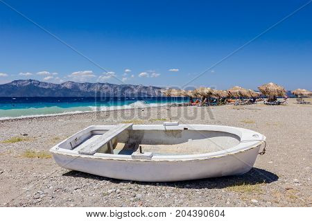 Small boat is dry docked withdrawn at the beach coastline.