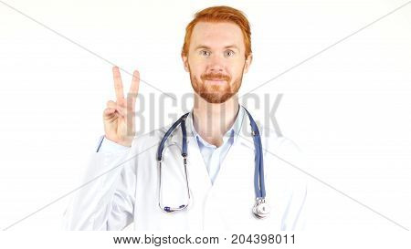 Portrait Of  Doctor Showing Victory Sign Against White Background