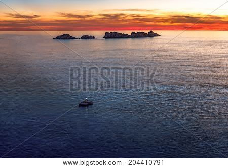 Lighthouse in sunset on island Grebeni, Dubrovnik, Croatia, view from Lapad peninsula