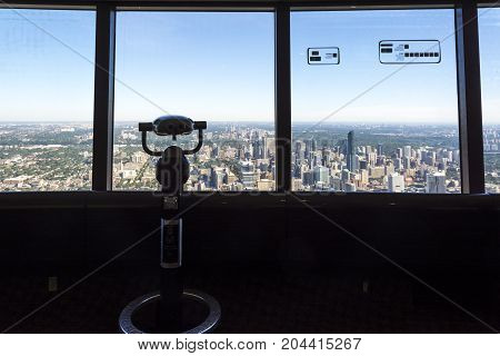 TORONTO,CANADA-AUGUST 2,2015:binoculars and view of Toronto city skyline from the top of the Cn tower during a sunny day.