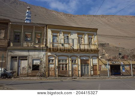 Pisagua, Tarapaca Region, Chile - August 21, 2017: Historic wooden buildings from the era of nitrate mining in the Atacama Desert, in the coastal town of Pisagua in northern Chile.