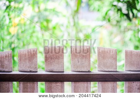 The wooden fence on the foreground and the background is nature.