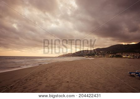 Sunset over Castelldefels beach in summer with clouds