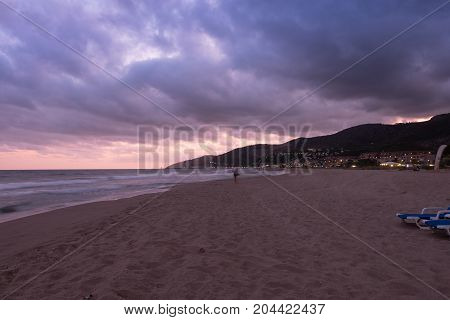 Sunset over Castelldefels beach in summer with clouds